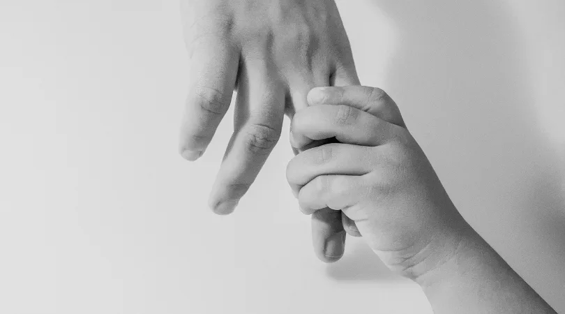 child and adult holding hands - to show teaching forgiveness to my children
